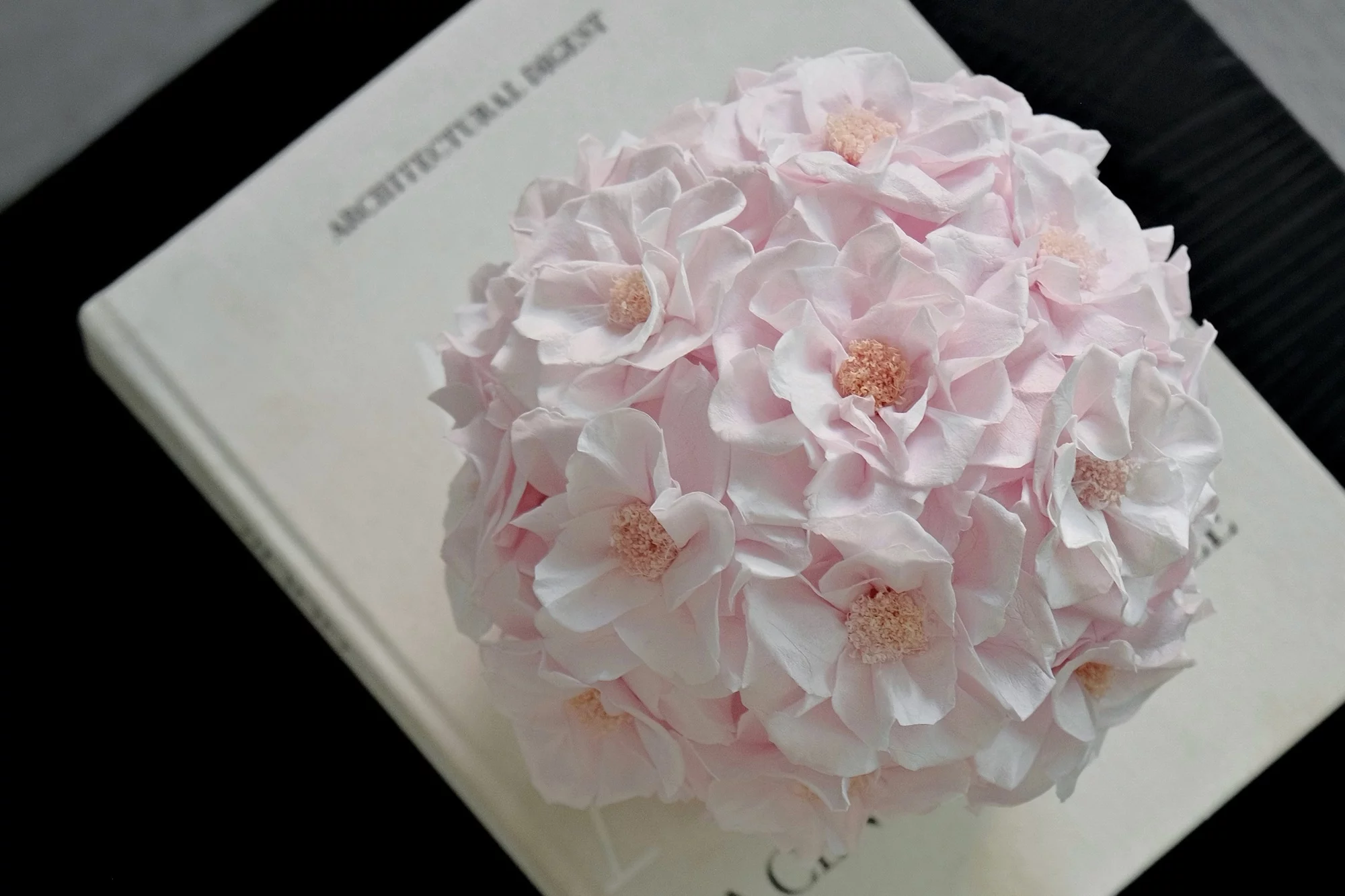 Delicate pink hydrangea bouquet on open cream-colored book titled Northern Lights